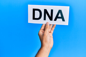 Hand of caucasian man holding paper with dna word over isolated white background