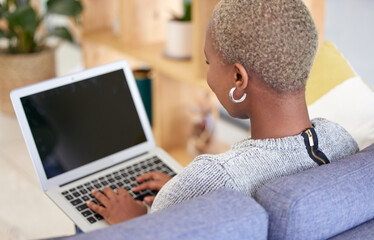 Black woman, blank laptop screen and relax on sofa for marketing mockup, online advertising and...