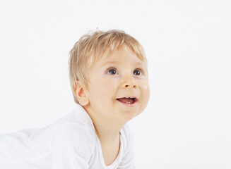 Little, happy and smiling cute baby in the studio. Portrait of a one year old baby. The concept of happiness.