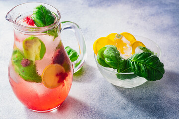 Strawberry basil lemonade iced jug pitcher over grey backdrop