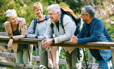 Elderly, people hiking and happy in park with fitness outdoor, relax on bridge while trekking in...