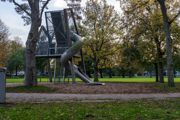Netherlands, Hague, Haagse Bos, metallic slide in playground