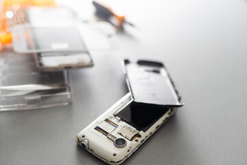 Technician repairing mobile phone at table, closeup
