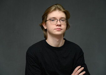 Young guy portrait in a black t-shirt on a gray background - 559125925