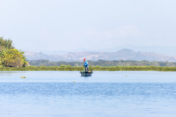 Fototapeta na wymiar Fisherman in the Olomega lagoon in San Miguel, El Salvador