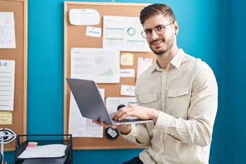 Young caucasian man business worker using laptop working at office