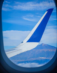 Teide volcano through the airplane window. Highest mountain in Spain located in Teide national park in Tenerife, Canary islands