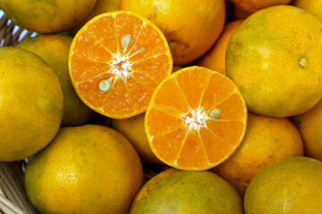 organic orange fruit Golden varieties in a basket on a white background which is an orange grown in the north of Thailand. Soft and selective focus.