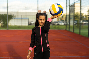 Cute girl playing ball. Girl with a blue-yellow volleyball