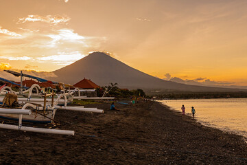 Breathtaking sunset view on Agung volcano from Amed beach in Bali, Indonesia