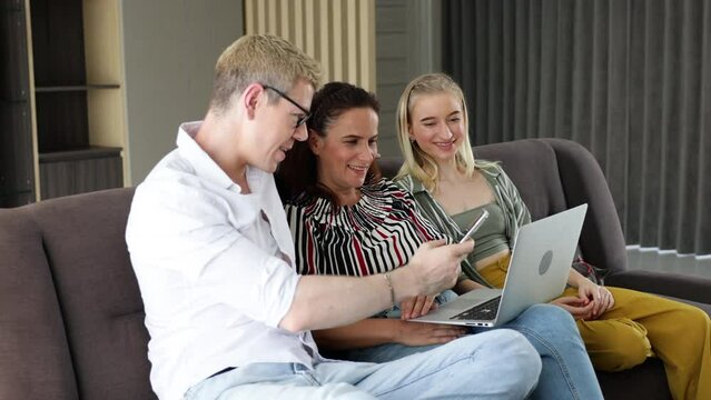 online shopping at home. Happy caucasian family online shopping by laptop computer and credit card at home.