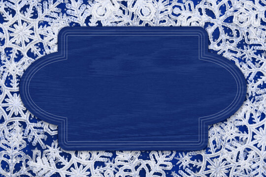 Blank blue wood sign on white snowflakes winter for your winter message