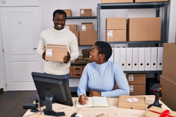 Man and woman ecommerce business workers writing on notebook at office