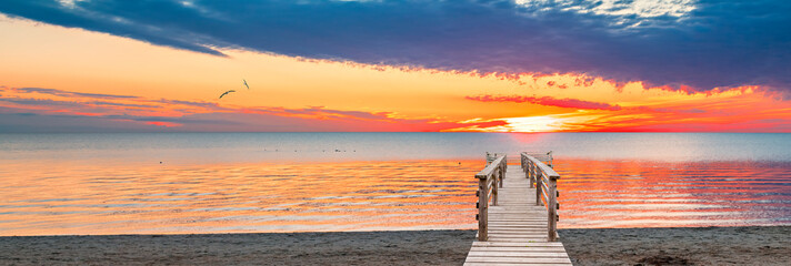 Wooden footpath leading to beach of the Baltic Sea, Jurmala – famous international resort in Latvia. Concept of happy summer vacations and bliss holidays