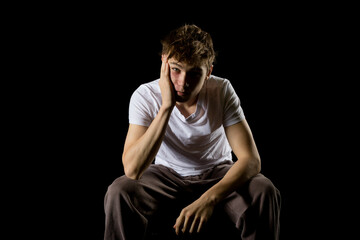 Portrait of a 17 year old boy on a black background