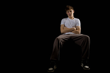 Portrait of a 17 year old boy on a black background