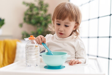 Adorable hispanic girl eating at home