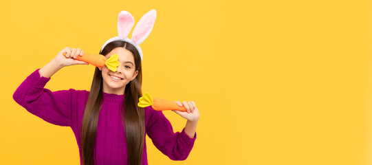lets play. happy teen girl wear bunny ears hold carrot. Easter child horizontal poster. Web banner header of bunny kid, copy space.