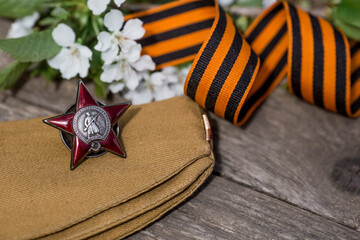 St. George's ribbon and the Order of the Red Star of the USSR World War II veteran on a wooden...