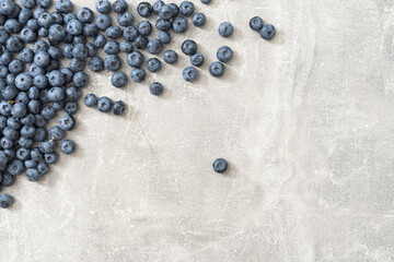 Fresh blueberries on gray background. Blueberries background. Healthy berry, organic food, antioxidant, vitamin, blue food.