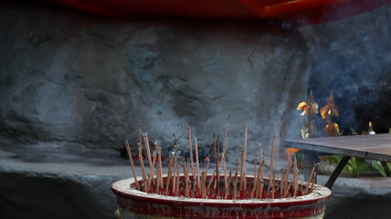 Smoke from burning incense stick in the dark