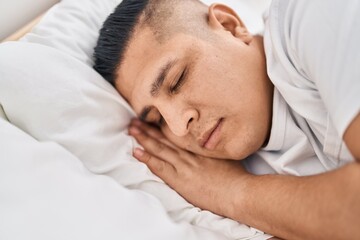 Fototapeta na wymiar Young latin man lying on bed sleeping at bedroom