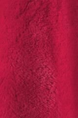 Red delicate soft vertical background of plush fabric. Viva Magenta color decor 