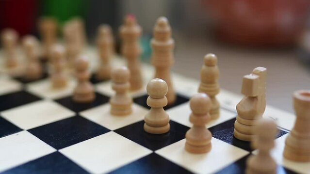 chessboard with combination of white and black wooden chess figures . Top view. High quality footage