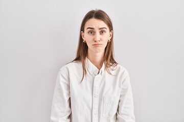 Obraz premium Young caucasian woman standing over isolated background depressed and worry for distress, crying angry and afraid. sad expression.