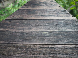 Image of an old wooden bridge used for walking into the garden. old plank with beautiful patterns
