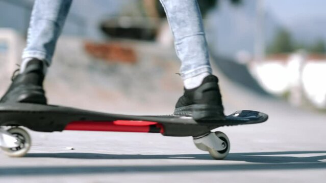 Legs on waveboard close up, Girl riding on casterboard with two wheels, modern street skate sports of teenagers, ripstick for balance ride.