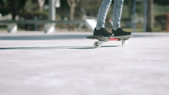 Girl riding on waveboard with two wheels, modern street skate sports of teenagers, casterboard or ripstick for balance ride.