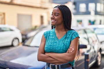 African american woman smiling confident standing with arms crossed gesture at street