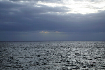 Magic of the Atlantic. Sunrise . Open ocean waves horizon and clouds. Bright colors.