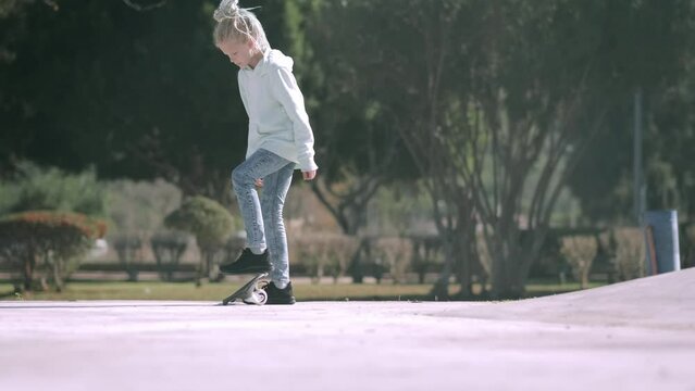 Girl riding on waveboard with two wheels, modern street skate sports of teenagers, casterboard or ripstick for balance ride.
