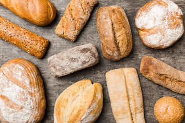Homemade natural breads. Different kinds of fresh bread as background, top view with copy space