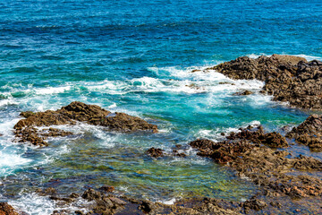 Clean and transparent waters in the sea of the city of Salvador in Bahia through the rocks