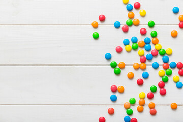 Mixed collection of colorful candy, on colored background. Flat lay, top view. frame of colorful chocolate coated candy