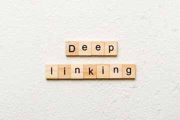 Deep Linking word written on wood block. Deep Linking text on cement table for your desing, concept