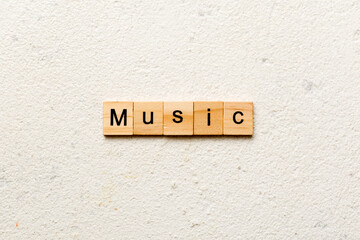 MUSIC word written on wood block. MUSIC text on cement table for your desing, concept
