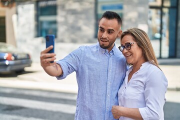 Man and woman mother and daugther having video call at street