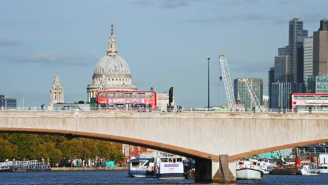 Red double decker bus crossing a bridge in London, England. The symbol of England. 