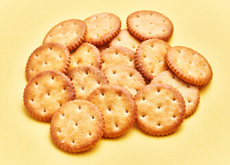  Delicious group of salty biscuits over isolated yellow background