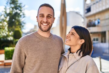Fototapeta premium Man and woman couple smiling confident hugging each other standing at park