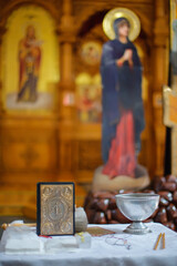 Throne, Holy Meal, Altar, antimension, gospel, altar cross, tabernacle and lampada and two crosses for the baptism of a child in an Orthodox church Defocused