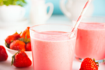 Glasses of strawberry milkshake or smoothie. Summer healthy vitamin beverage, diet or vegan food