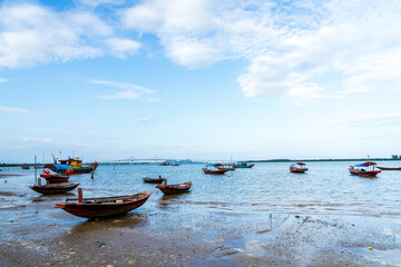 Fototapeta premium The scenery of the estuary with the bridge crossing is very beautiful, the sky is clear and the small boats are ready to go fishing