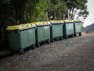 Large rubbish wheelie bins, green with yellow lid