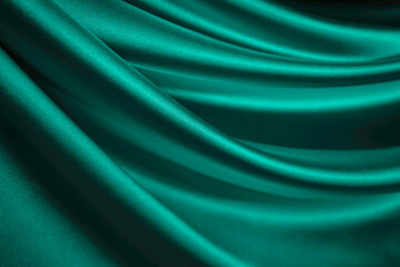 Blue green silk satin. Emerald curtain. Drapery. Shiny fabric. Elegant background for design. Liquid, wave, ripple effect. Beautiful soft folds. Christmas, Valentine.