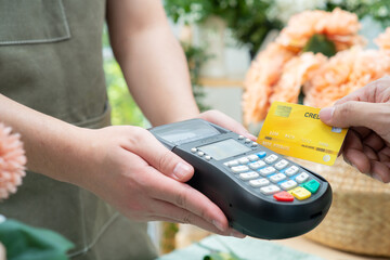 Money,Financial and pay technology concept.Business man holding credit card reader machine and...